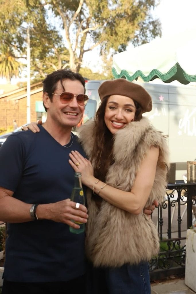 A couple pose for a photo at a coffee shop party