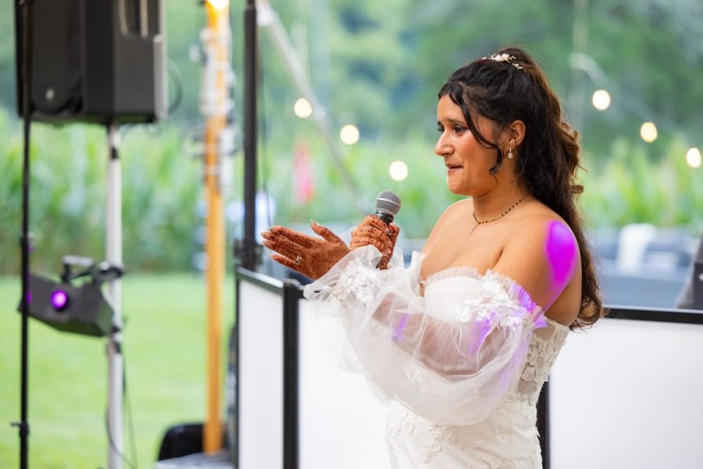 Bride makes a speech at an outdoor reception