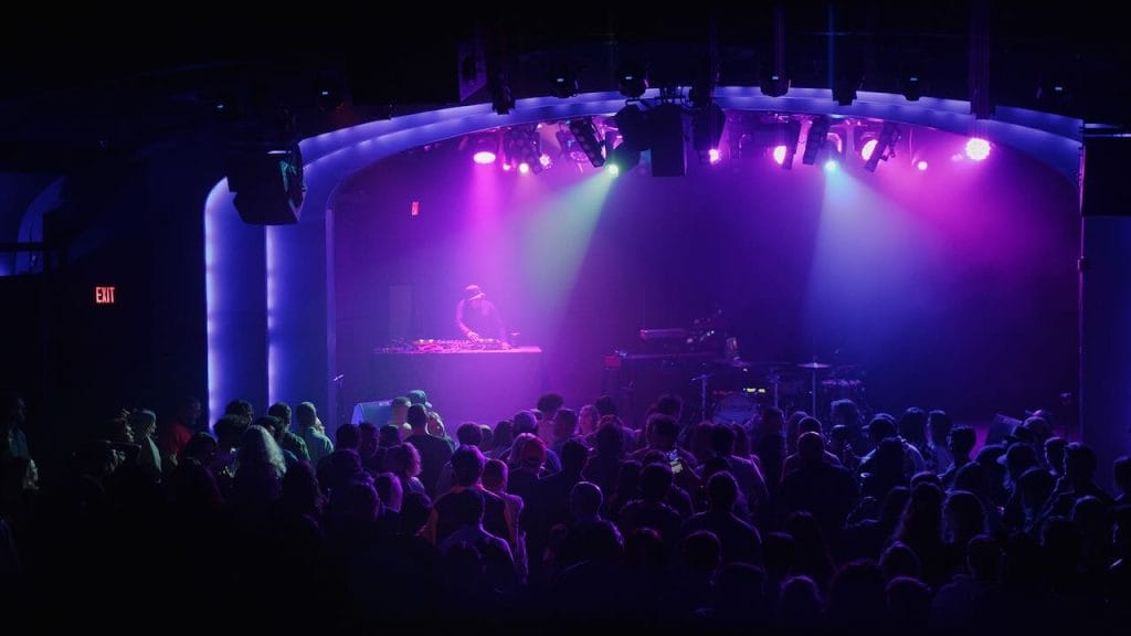 DJ Bhoosh on stage in front of a packed audience