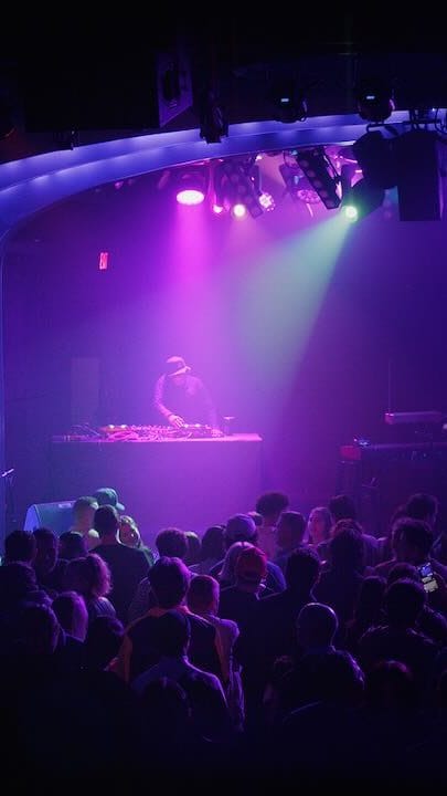 DJ Bhoosh on stage in front of a packed audience