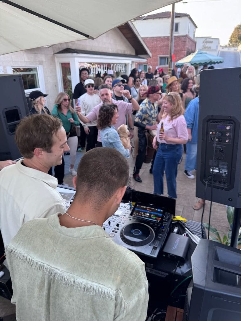 DJs playing music for a crowd at a coffee shop