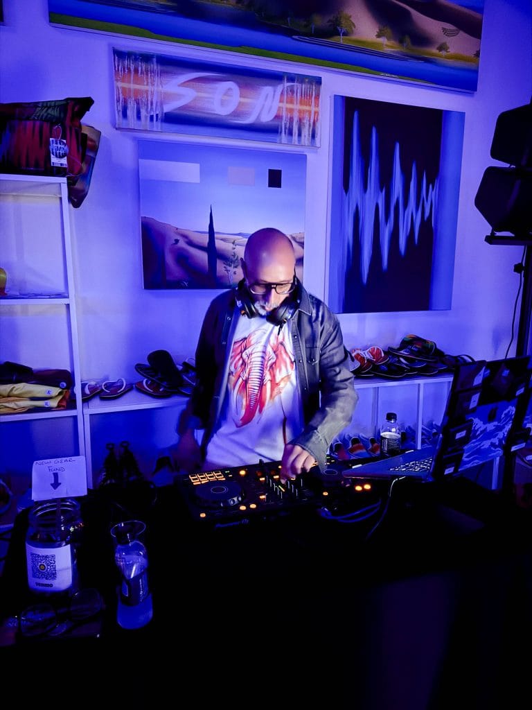 Man DJ spinning in a gallery